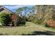 Landscaped backyard with mature trees and lush grass at 4505 70Th E Ave, Ellenton, FL 34222