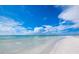 Expansive beach with clear water under a blue sky at 475 Benjamin Franklin Dr # 215, Sarasota, FL 34236