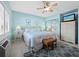 Main bedroom with king-size bed, wicker furniture, and tiled floors at 475 Benjamin Franklin Dr # 215, Sarasota, FL 34236