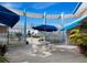 Relaxing courtyard with tables and umbrellas at 475 Benjamin Franklin Dr # 215, Sarasota, FL 34236