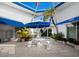 Inviting courtyard with tables, benches, and umbrellas at 475 Benjamin Franklin Dr # 215, Sarasota, FL 34236