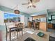 Dining area with kitchen view, light wood table and chairs at 475 Benjamin Franklin Dr # 215, Sarasota, FL 34236
