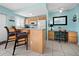 Fully equipped kitchen with light wood cabinets and a breakfast bar at 475 Benjamin Franklin Dr # 215, Sarasota, FL 34236