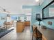 Bright kitchen with island, light wood cabinets, and dining area at 475 Benjamin Franklin Dr # 215, Sarasota, FL 34236