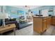 Living room with a light blue wall, gray couch, and dining area with a view at 475 Benjamin Franklin Dr # 215, Sarasota, FL 34236