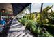 Outdoor restaurant seating area with lush landscaping at 475 Benjamin Franklin Dr # 215, Sarasota, FL 34236