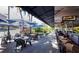 Restaurant patio with umbrella-shaded tables and chairs at 475 Benjamin Franklin Dr # 215, Sarasota, FL 34236