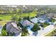 Aerial view of the home showcasing its location within a well-kept community near a golf course and pond at 4837 88Th E St, Bradenton, FL 34211