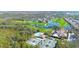 Aerial view of a golf course, community pool, tennis courts, and surrounding neighborhood at 4837 88Th E St, Bradenton, FL 34211