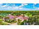 Aerial view of the clubhouse, lush green landscape, and golf course at 4837 88Th E St, Bradenton, FL 34211