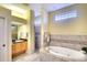 Well-lit bathroom featuring a soaking tub, glass block window and a separate shower at 4837 88Th E St, Bradenton, FL 34211