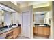 Bathroom featuring double sinks with a granite countertop and a white door at 4837 88Th E St, Bradenton, FL 34211