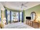 Bright bedroom with green walls, tile flooring, and natural light from large windows at 4837 88Th E St, Bradenton, FL 34211