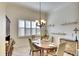Dining room with wood table, elegant chandelier, and large window with shutters at 4837 88Th E St, Bradenton, FL 34211