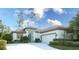 Charming single-story home featuring a two-car garage, well-manicured landscaping, and a blue front door at 4837 88Th E St, Bradenton, FL 34211