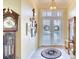 Inviting foyer with a decorative rug, classic grandfather clock, and a charming mirror and table set at 4837 88Th E St, Bradenton, FL 34211