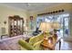 Elegant living room featuring a display cabinet, comfortable seating and doors leading to an outside patio area at 4837 88Th E St, Bradenton, FL 34211