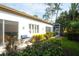 Relaxing outdoor patio area with a grill, sliding door access and view of verdant landscaping at 4837 88Th E St, Bradenton, FL 34211