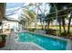 Screened-in pool and patio area with lush landscaping and golf course views at 4837 88Th E St, Bradenton, FL 34211