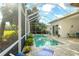Screened-in pool area with a poolside lounge chair and views of the golf course at 4837 88Th E St, Bradenton, FL 34211