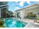 Backyard with a screened-in pool, patio furniture, and access to the home's interior at 4837 88Th E St, Bradenton, FL 34211