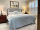 Spacious main bedroom with king-size bed, ample nightstands, and a large window at 5324 Popoli Way, Sarasota, FL 34238