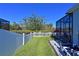 Backyard with white fence, grass, and access to a patio at 5522 69Th E Pl, Ellenton, FL 34222
