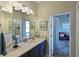 Bathroom with vanity, sink, and access to a relaxing screened porch at 5522 69Th E Pl, Ellenton, FL 34222