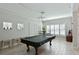 Game room with a pool table and built-in shelving at 5522 69Th E Pl, Ellenton, FL 34222