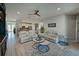 Spacious living room with light beige couches, coffee table, and a view into the kitchen at 5522 69Th E Pl, Ellenton, FL 34222
