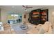 Living room featuring a large entertainment center, comfortable seating, and access to a patio at 5522 69Th E Pl, Ellenton, FL 34222