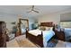 Bright main bedroom with a king-size bed, large mirror, and ample natural light at 5522 69Th E Pl, Ellenton, FL 34222