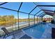 Screened pool and patio area with lake view at 5522 69Th E Pl, Ellenton, FL 34222