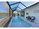 Inviting screened pool area with fountain and lake view at 5522 69Th E Pl, Ellenton, FL 34222