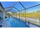 Relaxing pool area with screened enclosure and lake view at 5522 69Th E Pl, Ellenton, FL 34222