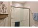 Clean and modern shower with glass enclosure and neutral tile at 5522 69Th E Pl, Ellenton, FL 34222