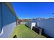 Side yard with grass, white fence, and storage containers at 5522 69Th E Pl, Ellenton, FL 34222