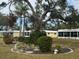 Landscaped courtyard with mature trees and seating area at 5931 Tidewood Ave # 8, Sarasota, FL 34231