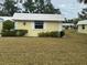Bright yellow house with white roof and grassy yard at 5931 Tidewood Ave # 8, Sarasota, FL 34231