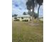 Cute yellow home with palm trees and grassy yard at 5931 Tidewood Ave # 8, Sarasota, FL 34231