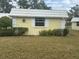 Quaint yellow house with white trim and a grassy yard at 5931 Tidewood Ave # 8, Sarasota, FL 34231
