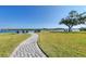 Brick paved pathway to waterfront patio with chairs at 6005 Midnight Pass Rd # N8, Sarasota, FL 34242