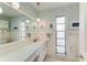 Clean bathroom with light vanity and a large mirror at 6005 Midnight Pass Rd # N8, Sarasota, FL 34242