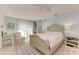 Spacious bedroom with a queen-size bed, a sitting chair, and plenty of natural light at 6005 Midnight Pass Rd # N8, Sarasota, FL 34242