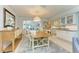 Elegant dining room with a wooden table and access to the kitchen at 6005 Midnight Pass Rd # N8, Sarasota, FL 34242