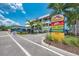 Modern commercial building with ample parking and signage for various businesses at 6005 Midnight Pass Rd # N8, Sarasota, FL 34242