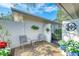 Inviting front patio with seating area and decorative gate at 6005 Midnight Pass Rd # N8, Sarasota, FL 34242