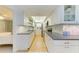 Modern kitchen with white cabinets, granite counters, and stainless steel appliances at 6005 Midnight Pass Rd # N8, Sarasota, FL 34242