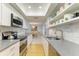 Modern kitchen with white cabinets, granite counters, and stainless steel appliances at 6005 Midnight Pass Rd # N8, Sarasota, FL 34242
