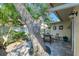 Private patio nestled under a large tree at 6005 Midnight Pass Rd # N8, Sarasota, FL 34242